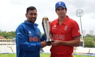 Indian captain Mahendra Sing Dhoni (L) and England captain Alistair Cook pose for photographs with the ICC Champions Trophy at Edgbaston in Birmingham, England on June 22, 2013 a day ahead of the 2013 ICC Champions Trophy Final cricket match between England and India. AFP PHOTO/Paul ELLIS - RESTRICTED TO EDITORIAL USE        (Photo credit should read PAUL ELLIS/AFP/Getty Images)
